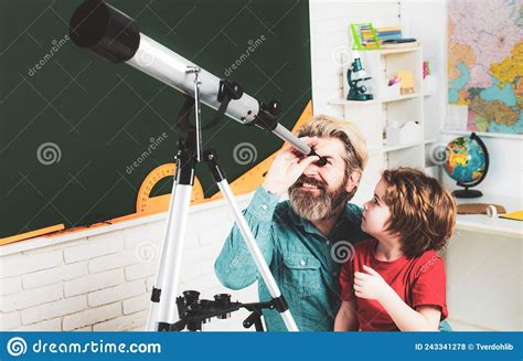 Pupil Watching Stars With A Teacher Astronomy Telescope Father