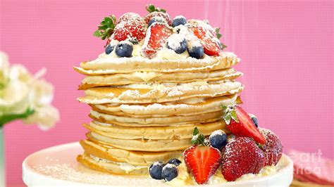 Pancake Tuesday stack of pancakes cake with whipped cream and fresh berries. Photograph by ...