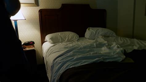 A Man Turns Off Light And Falls Asleep In A Hotel Room Late At Night