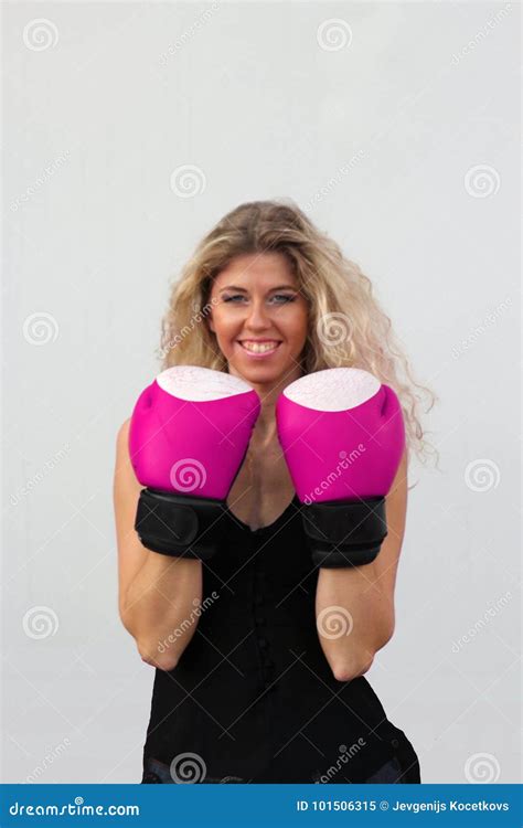 Blonde Girl In Black Casual Dress In Pink Boxing Gloves Stock Image
