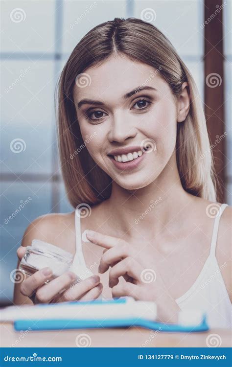 adorable woman dipping her finger into the cream stock image image of millennial moisturizer