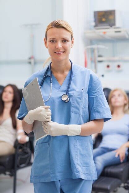 Premium Photo Nurse Standing While Holding A Clipboard