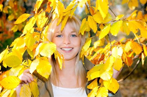 Young Woman Looks Through Autumn Leaves Stock Image Image Of