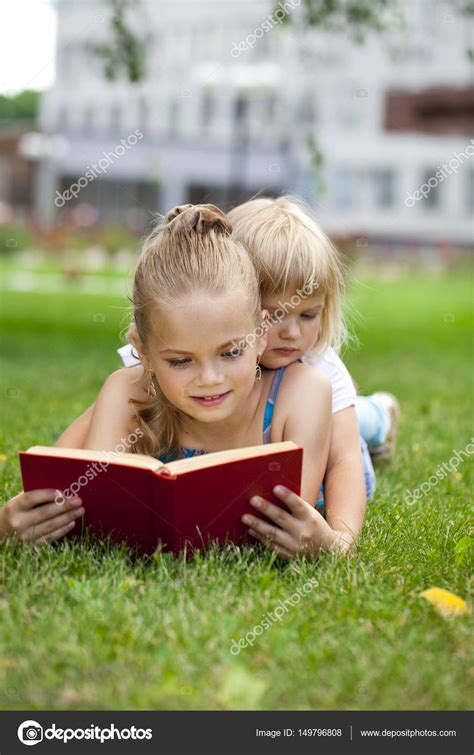 Adorable Cute Little Girl Reading Book Outside On Grass — Stock Photo