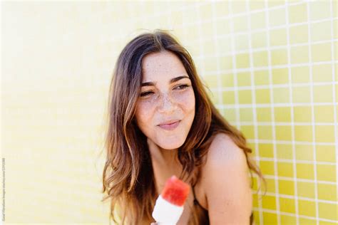 Woman In Bikini Eating A Popsicle By Stocksy Contributor Vero