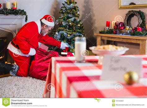 Santa Claus Putting Presents In Christmas Bag Stock Image Image Of