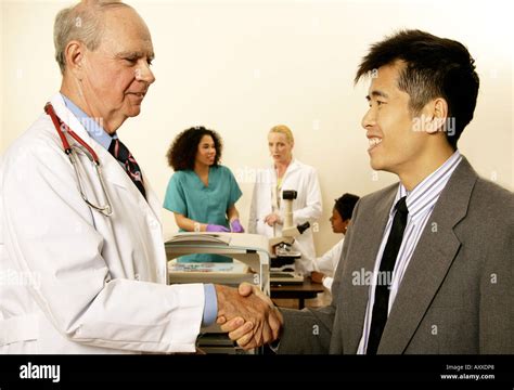 Medical device sales representative or salesman visits docot in his