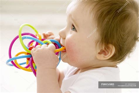 Portrait Of Baby Boy Chewing On Teething Ring — Development Sucking