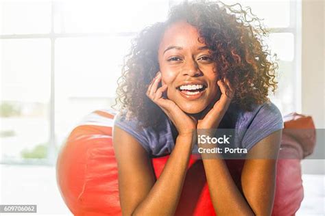 Young Woman Lying On Bean Bag At Home Stock Photo Download Image Now