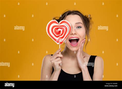 Happy Excited Young Woman Covered Her Eye With Bright Heart Shaped
