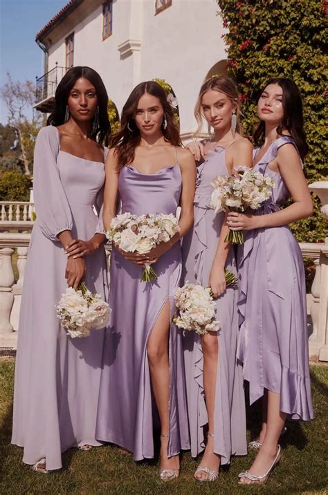 Four Bridesmaids In Lavender Dresses Posing For A Photo Outside The