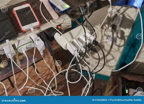 Charging Phones And Other Devices In A Mess Editorial Photography