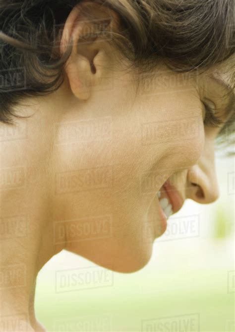 Woman Smiling And Looking Down Close Up Side View Of Face Stock