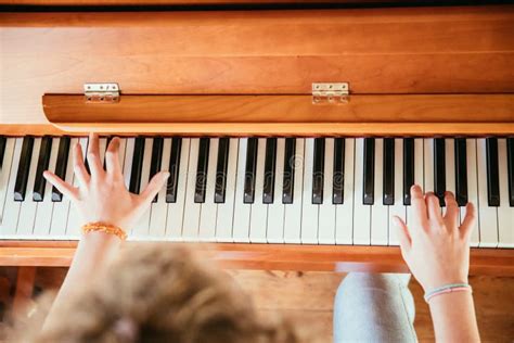 Girl Is Playing Piano At Home High Angle View Blurry Background Stock