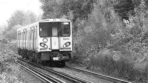 Grayscale Shot Of An Old Merseyrail Train Wagon Abandoned On A Railroad