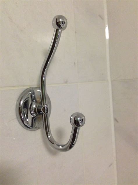 A Close Up Of A Shower Handle On A Tiled Wall