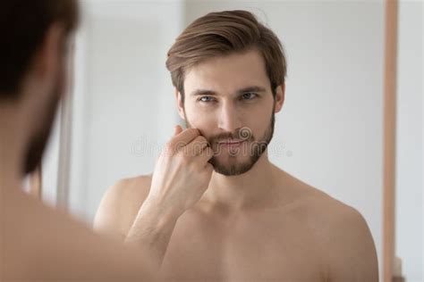 Close Up Mirror Reflection Handsome Young Man Touching Beard Stock