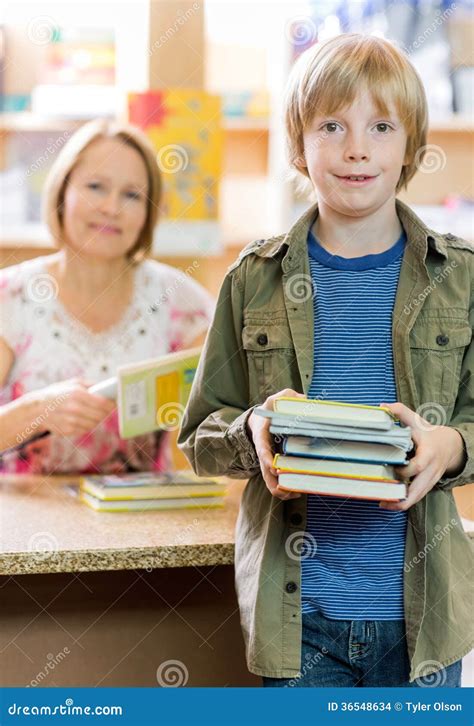 Schoolboy Checking Out Books From Library Stock Photo Image Of