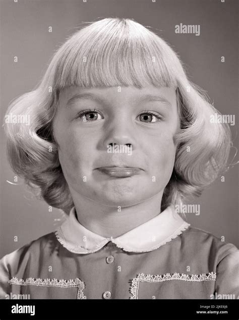 1960s Cute Blonde Girl With Amused Facial Expression Jutting Out Her