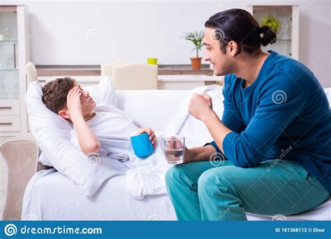 Young Father Caring For Sick Son Stock Photo Image Of Medicine