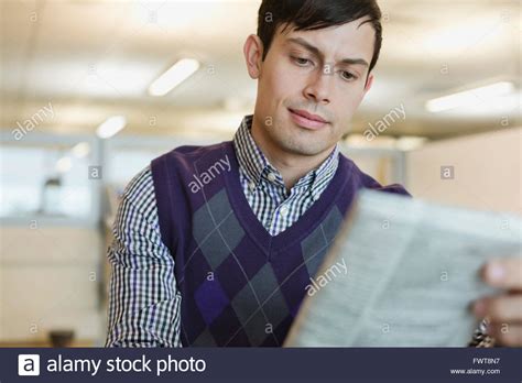 Businessman Reading Newspaper In Office Stock Photo Alamy