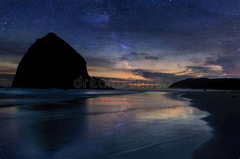 Haystack Rock Under Starry Night Sky Along Oregon Coast Stock Image