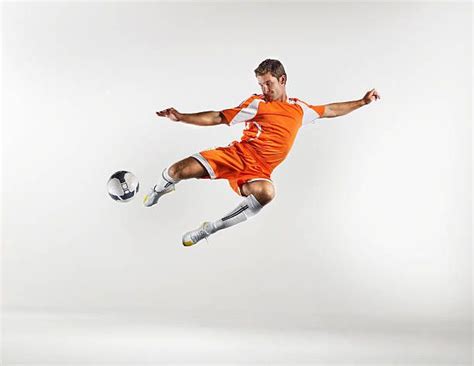 Soccer Player Kicking A Volley Midair Soccer Soccer Players Volley