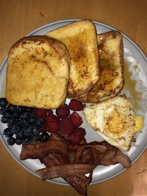 Homemade French Toast Breakfast With Fried Egg Berries And Bacon R