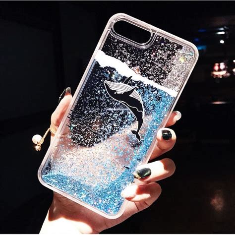 A Person Holding Up A Phone Case With A Whale On Its Back And Glitter