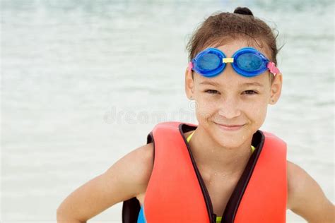 Smiling Preteen Girl Standing Under Water Drops Blurred Waterpark In Background Stock Image