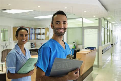 Nurses Smiling In Hospital Hallway Stock Photo Dissolve
