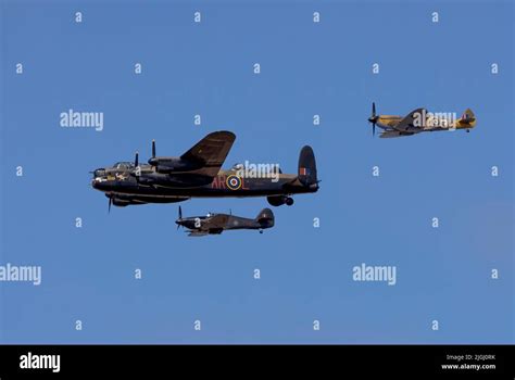 An Raf Hurricane And Spitfire Flank A Lancaster Bomber Forming The