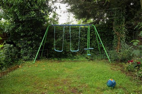 Empty Swing Set In Backyard Stock Photo Dissolve