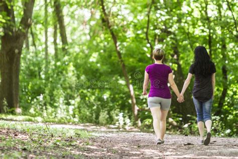 Girlfriends Taking A Walk Through The Park Horizontal Stock Image