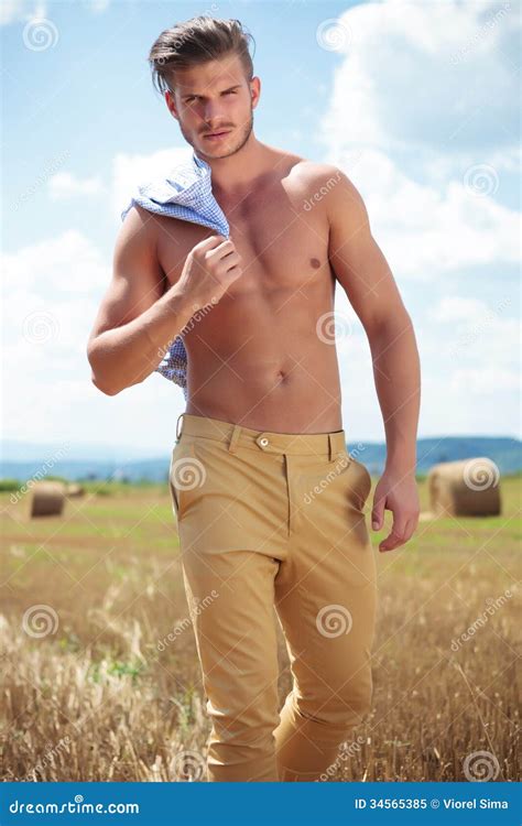Topless Man Outdoor Looks At You With Shirt On Shoulder Stock Image Image Of Holding Hand