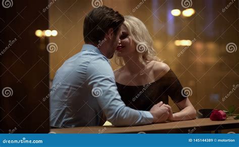 Loving Couple Kissing In Restaurant Enjoying Each Other Romantic Date