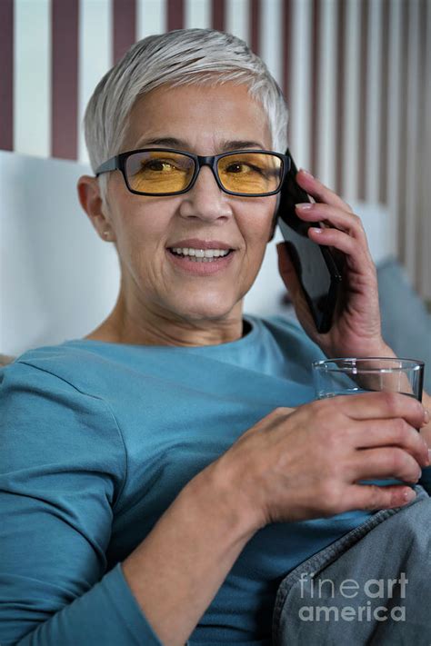 Mature Woman Wearing Blue Light Blocking Glasses Photograph By Microgen