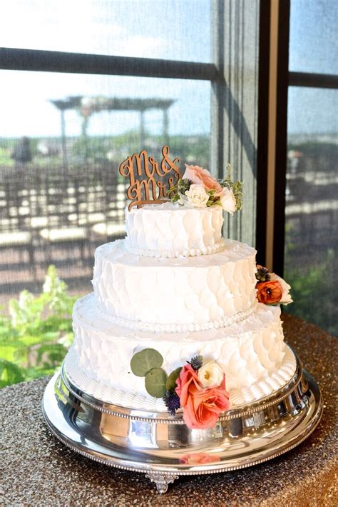 White Buttercream Wedding Cake With Coral Flowers