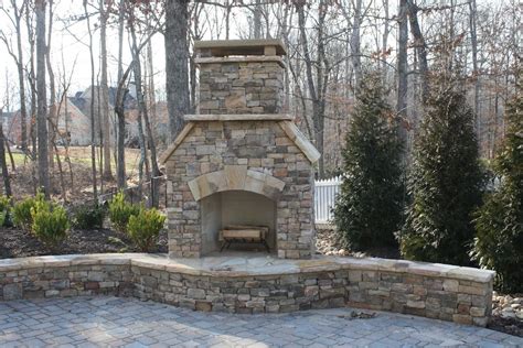 Outdoor Stacked Stone Fireplace With Hearth And Seating Wall Outdoor