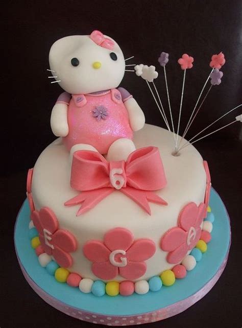 Bake a two tier cake and use some unique cake accessories to decorate it and make it look beautiful. Hello Kitty six-year-old cake with pink flowers and ribbon.JPG (3 comments)