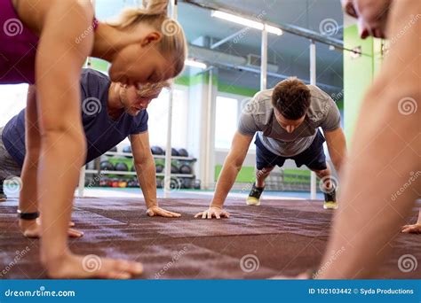 Group Of People Doing Straight Arm Plank In Gym Stock Photo Image Of