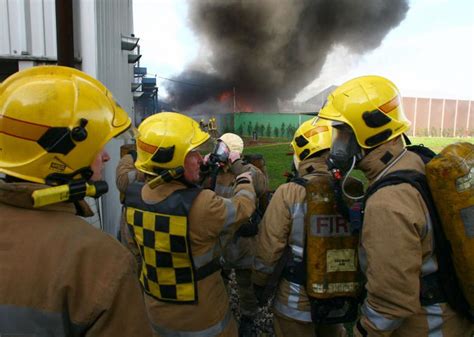 Firefighters Search For Survivors In Factory Fire