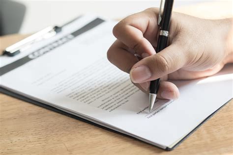 Close Up Of A Person Signing A Document 1309382 Stock Photo At Vecteezy
