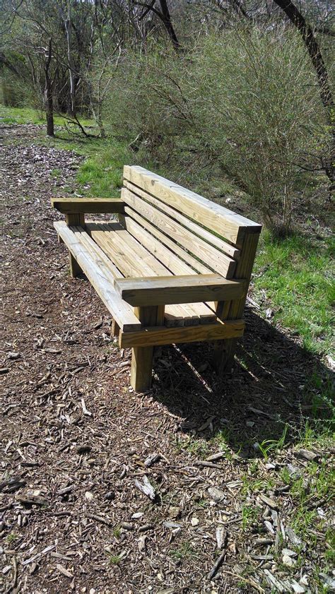 A Wooden Bench Along The Walking Trail Wooden Bench Modern Bench Bench
