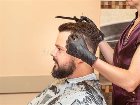 Hairdresser Cutting Males Hair With Scissor And Comb Close Up View