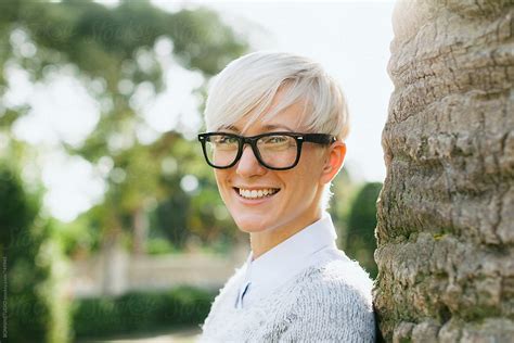 Blonde Woman Wearing Rimmed Glasses Standing On The Park By