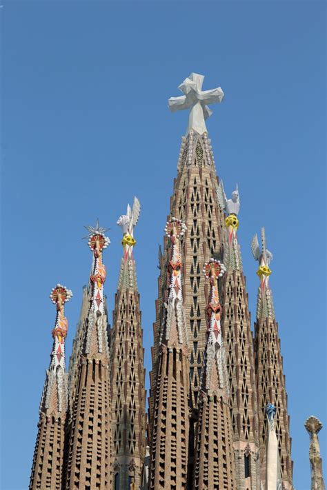 The Top Of A Building With Statues On It S Sides And A Cross In The Middle