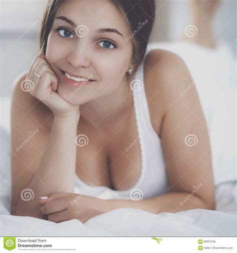 Beautiful Young Woman Lying In Bed Comfortably And Blissfully Stock