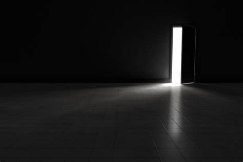 Open Door To Dark Room With Bright Light Shining In Background