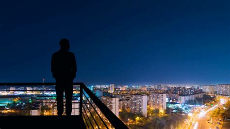 The Man Standing On The Top Of Building On The Night